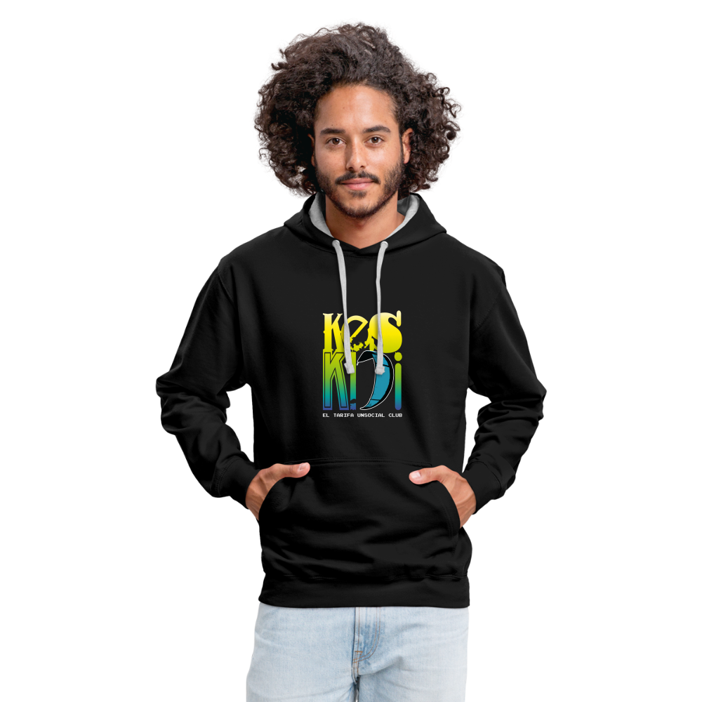 Man wearing colorful Keskidi KITE Tarifa bicolor hoodie, promoting online street-surf wear and beach lifestyle vibes.